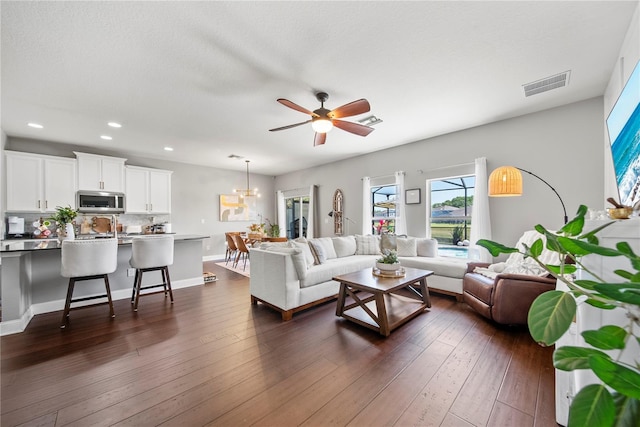 living room featuring recessed lighting, a ceiling fan, dark wood-type flooring, and baseboards