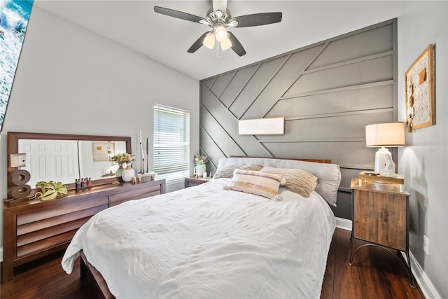 bedroom featuring wood finished floors, baseboards, and a ceiling fan