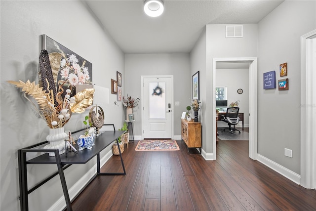entrance foyer with dark wood-style floors and baseboards
