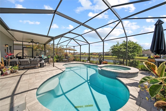 view of swimming pool with a patio area, outdoor lounge area, a pool with connected hot tub, ceiling fan, and a water view