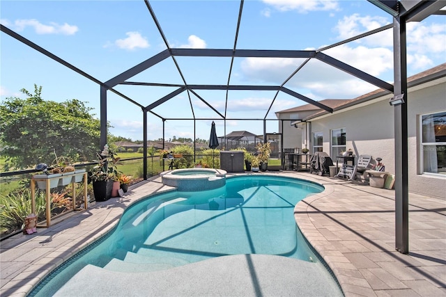 view of pool with a patio, a pool with connected hot tub, and a lanai