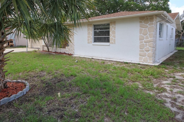 7904 Judith Cres, Port Richey, FL 34668 - view of home's exterior featuring a yard, stone siding, and roof with shingles
