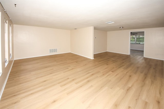 7904 Judith Cres, Port Richey, FL 34668 - empty room featuring light wood-style floors, baseboards, and fire sprinkler in ceiling