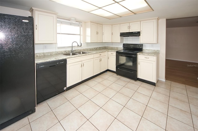 7904 Judith Cres, Port Richey, FL 34668 - kitchen featuring black appliances, a sink, under cabinet range hood, light tile patterned floors, and baseboards