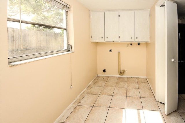 7904 Judith Cres, Port Richey, FL 34668 - clothes washing area featuring electric dryer hookup, cabinet space, light tile patterned flooring, and baseboards
