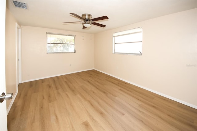 7904 Judith Cres, Port Richey, FL 34668 - empty room with a ceiling fan, light wood finished floors, healthy amount of natural light, and baseboards