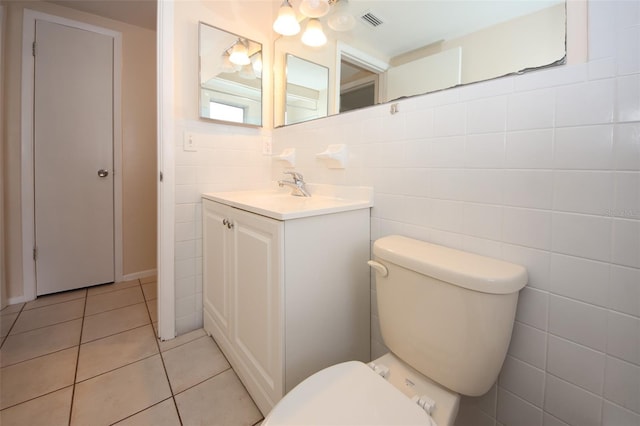 7904 Judith Cres, Port Richey, FL 34668 - bathroom with toilet, tile patterned flooring, vanity, and tile walls