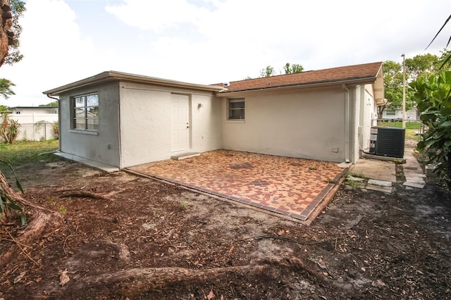 7904 Judith Cres, Port Richey, FL 34668 - rear view of property featuring stucco siding, a patio, cooling unit, and fence