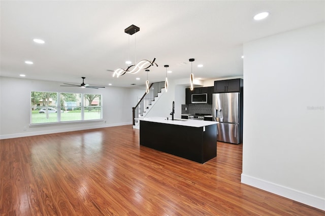 226 Willowick Ave, Temple Terrace, FL 33617 - kitchen featuring appliances with stainless steel finishes, a sink, dark cabinetry, light countertops, and baseboards