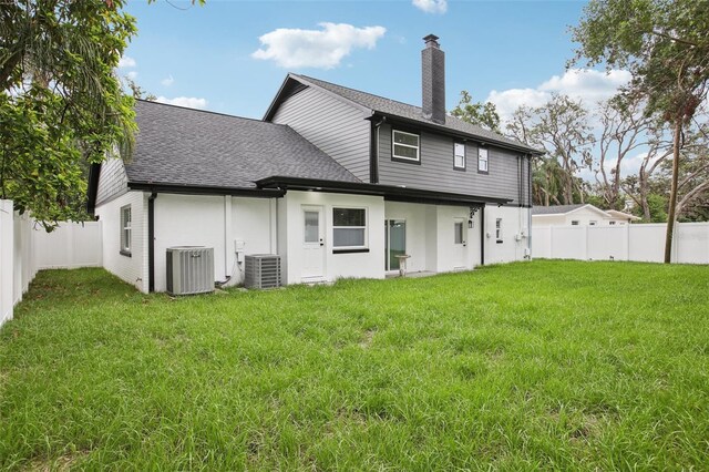 226 Willowick Ave, Temple Terrace, FL 33617 - back of property featuring a chimney, central AC unit, roof with shingles, and stucco siding