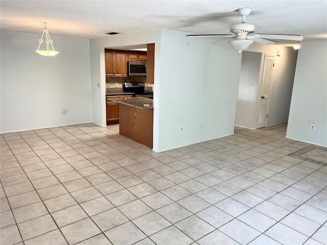 647 Fairmont Ave Unit C, Safety Harbor, FL 34695 - unfurnished living room featuring ceiling fan and a textured ceiling