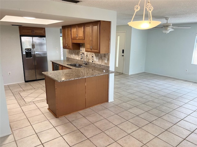 647 Fairmont Ave Unit C, Safety Harbor, FL 34695 - kitchen featuring stainless steel refrigerator with ice dispenser, a sink, light tile patterned floors, backsplash, and a textured ceiling