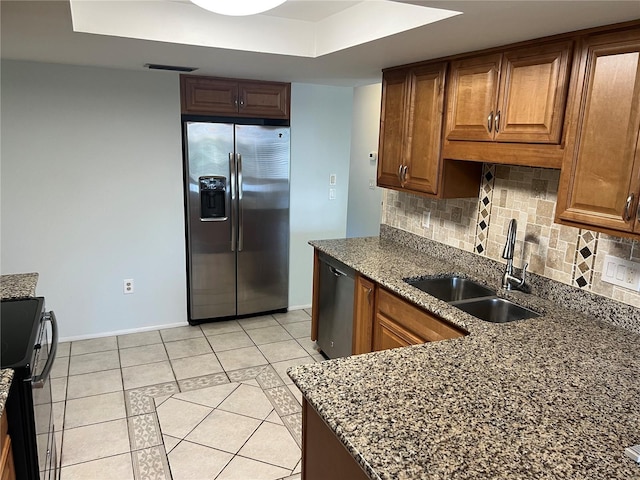647 Fairmont Ave Unit C, Safety Harbor, FL 34695 - kitchen with appliances with stainless steel finishes, a sink, decorative backsplash, and light tile patterned flooring