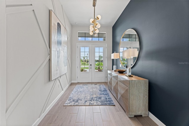 10447 New Brunswick St, Port Charlotte, FL 33981 - foyer entrance with a chandelier, wood finished floors, and baseboards