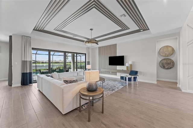 10447 New Brunswick St, Port Charlotte, FL 33981 - living room with a raised ceiling, baseboards, and light wood-style floors