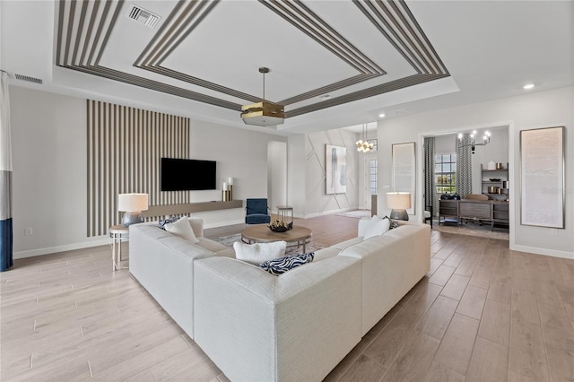 10447 New Brunswick St, Port Charlotte, FL 33981 - living room with a tray ceiling, a chandelier, baseboards, light wood-style floors, and recessed lighting