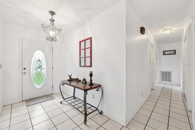 2013 Capri Rd, Valrico, FL 33594 - entryway featuring light tile patterned floors and a chandelier