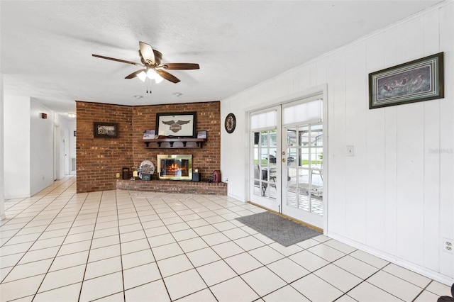 2013 Capri Rd, Valrico, FL 33594 - unfurnished living room featuring a ceiling fan, a brick fireplace, brick wall, and a textured ceiling