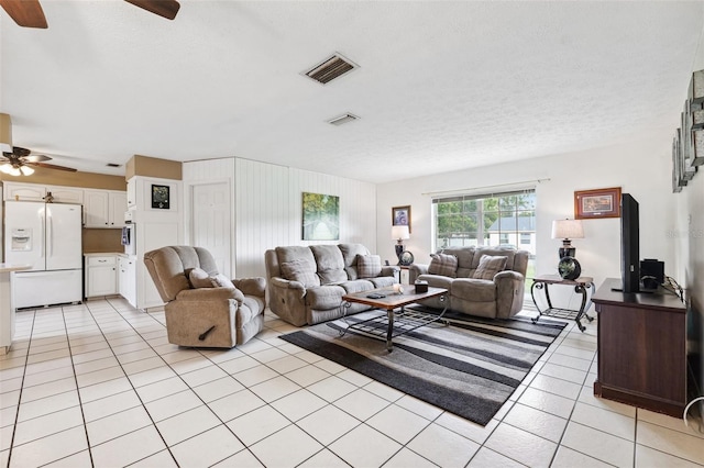 2013 Capri Rd, Valrico, FL 33594 - living room with a ceiling fan, light tile patterned floors, and a textured ceiling