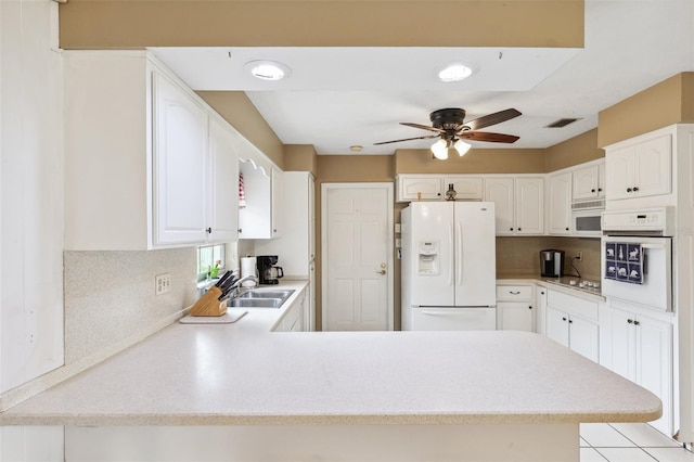 2013 Capri Rd, Valrico, FL 33594 - kitchen with white appliances, ceiling fan, light countertops, and a peninsula