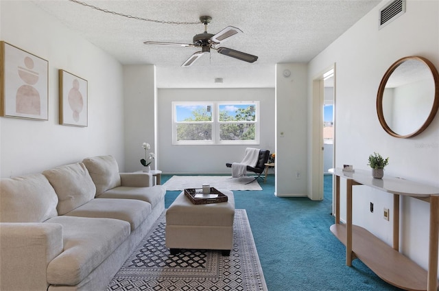 801 83rd Ave N Unit 209, Saint Petersburg, FL 33702 - carpeted living room with ceiling fan, a textured ceiling, and baseboards