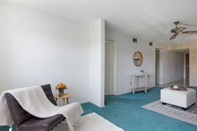 801 83rd Ave N Unit 209, Saint Petersburg, FL 33702 - sitting room with carpet flooring, ceiling fan, a textured ceiling, and baseboards