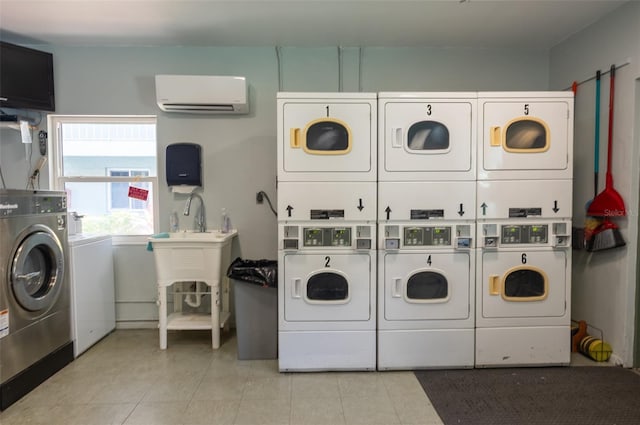 801 83rd Ave N Unit 209, Saint Petersburg, FL 33702 - communal laundry room with stacked washing machine and dryer, washing machine and dryer, a wall mounted air conditioner, and tile patterned flooring