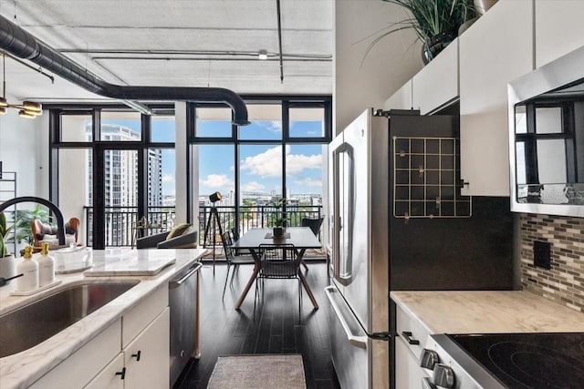 175 S 2nd St S Ph-16, Saint Petersburg, FL 33701 - kitchen with a sink, appliances with stainless steel finishes, backsplash, dark wood-style flooring, and expansive windows