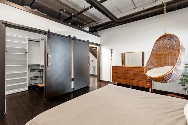 175 S 2nd St S Ph-16, Saint Petersburg, FL 33701 - bedroom featuring a barn door, wood finished floors, a walk in closet, and baseboards