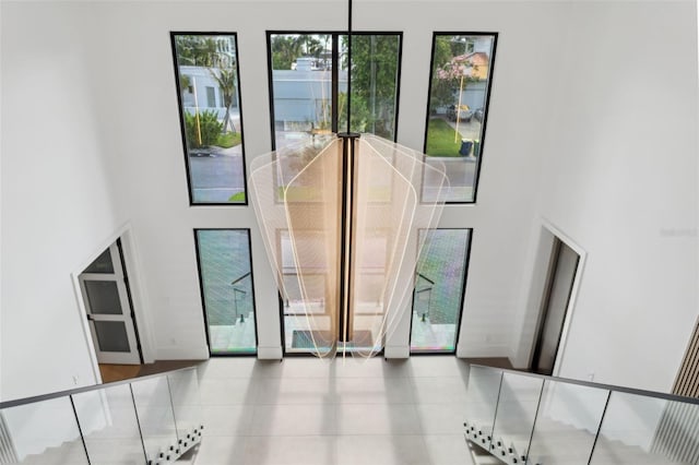 2902 S Beach Dr, Tampa, FL 33629 - staircase featuring a high ceiling and tile patterned flooring