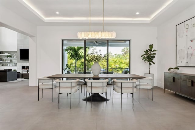 2902 S Beach Dr, Tampa, FL 33629 - dining space with a tray ceiling, a fireplace, and light tile patterned floors