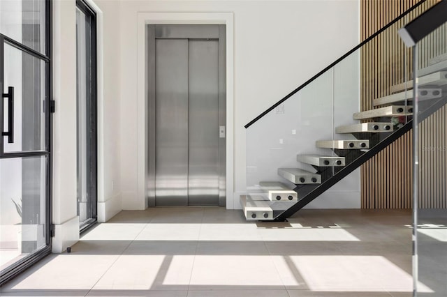 2902 S Beach Dr, Tampa, FL 33629 - stairway featuring elevator and tile patterned flooring