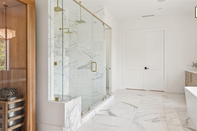 2902 S Beach Dr, Tampa, FL 33629 - full bath featuring a marble finish shower, marble look tiles, and a freestanding bath