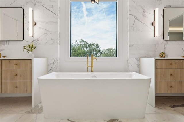 2902 S Beach Dr, Tampa, FL 33629 - bathroom with marble finish flooring, a soaking tub, and vanity