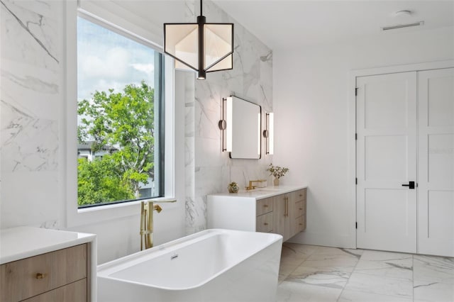 2902 S Beach Dr, Tampa, FL 33629 - bathroom with a soaking tub, marble finish flooring, and vanity