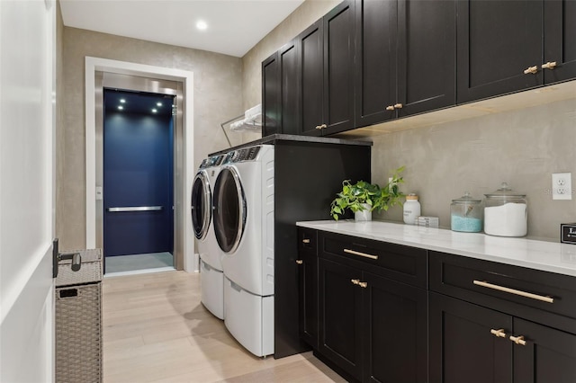 2902 S Beach Dr, Tampa, FL 33629 - washroom with washer and dryer, cabinet space, and light wood finished floors