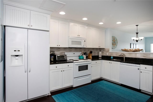 399 2nd St Unit 417, Indian Rocks Beach, FL 33785 - kitchen featuring white appliances, a sink, dark countertops, white cabinets, and recessed lighting