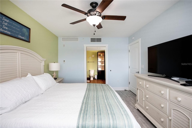 399 2nd St Unit 417, Indian Rocks Beach, FL 33785 - bedroom featuring light wood finished floors, baseboards, ensuite bathroom, and ceiling fan