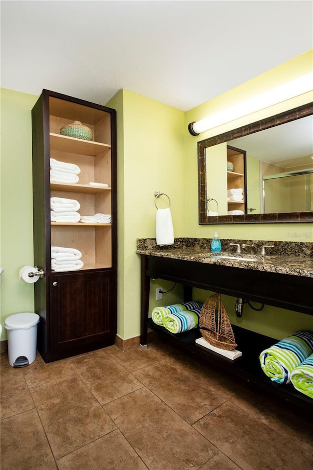 399 2nd St Unit 417, Indian Rocks Beach, FL 33785 - bathroom with tile patterned floors, vanity, and baseboards