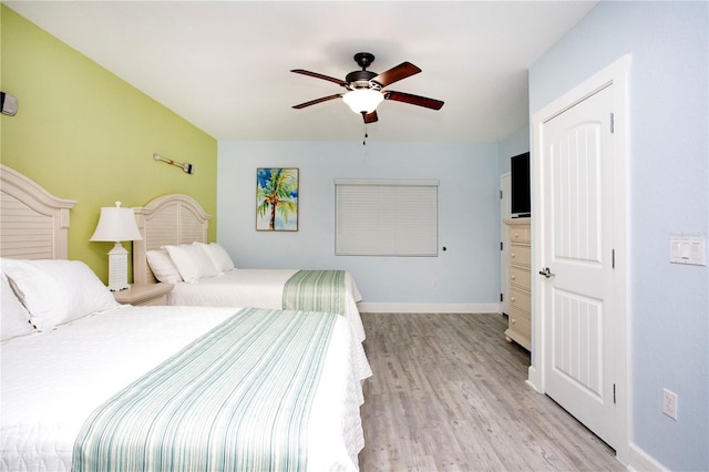 399 2nd St Unit 417, Indian Rocks Beach, FL 33785 - bedroom with light wood-style floors, baseboards, and a ceiling fan