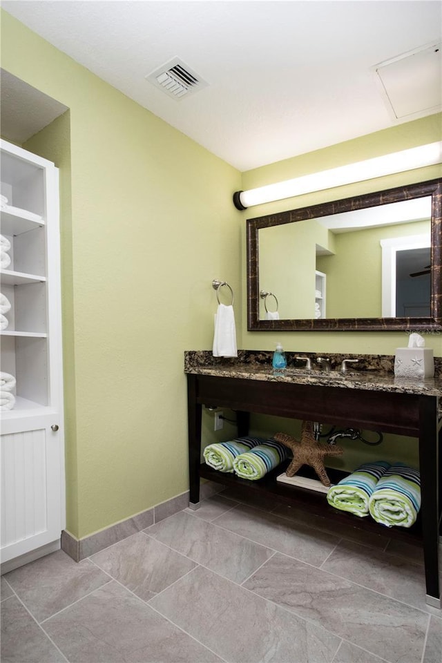 399 2nd St Unit 417, Indian Rocks Beach, FL 33785 - bathroom featuring baseboards and a sink