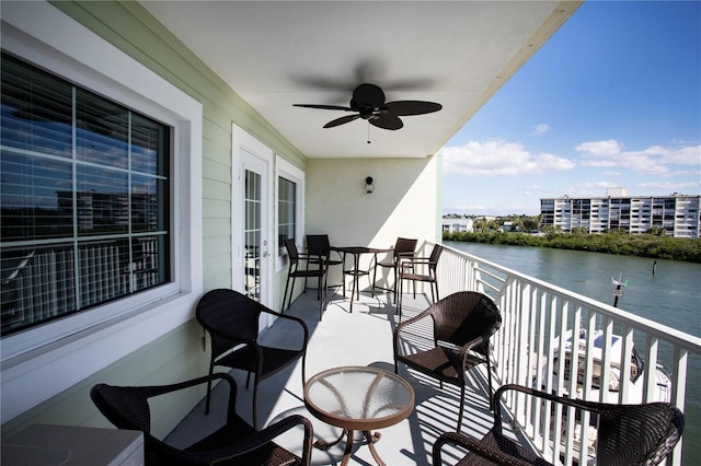 399 2nd St Unit 417, Indian Rocks Beach, FL 33785 - balcony featuring a water view, a ceiling fan, and french doors