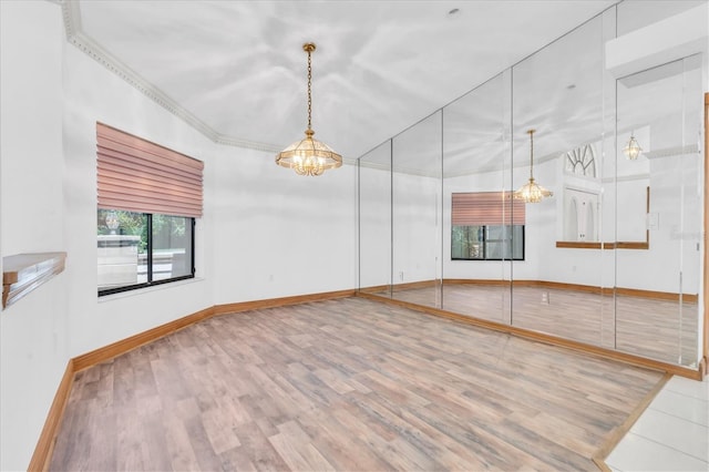 8827 Scout Lake Ct, New Port Richey, FL 34654 - unfurnished room featuring wood finished floors, a chandelier, and baseboards