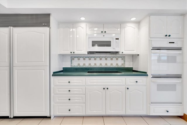 8827 Scout Lake Ct, New Port Richey, FL 34654 - kitchen with white appliances, dark countertops, white cabinets, decorative backsplash, and recessed lighting