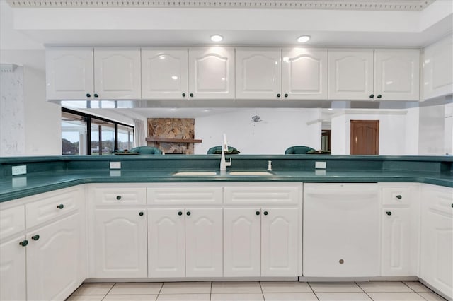 8827 Scout Lake Ct, New Port Richey, FL 34654 - kitchen featuring dishwasher, dark countertops, and white cabinets