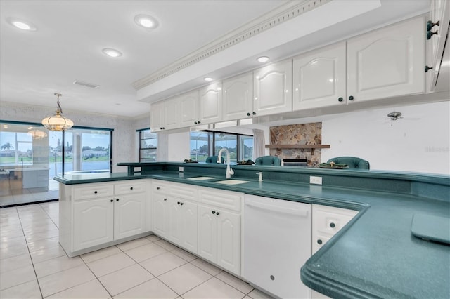 8827 Scout Lake Ct, New Port Richey, FL 34654 - kitchen with dishwasher, a sink, dark countertops, a peninsula, and white cabinetry