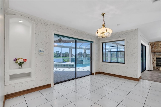 8827 Scout Lake Ct, New Port Richey, FL 34654 - unfurnished dining area with baseboards, ornamental molding, a water view, wallpapered walls, and light tile patterned floors