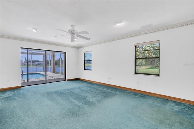 8827 Scout Lake Ct, New Port Richey, FL 34654 - empty room with baseboards, carpet floors, ornamental molding, a ceiling fan, and a water view