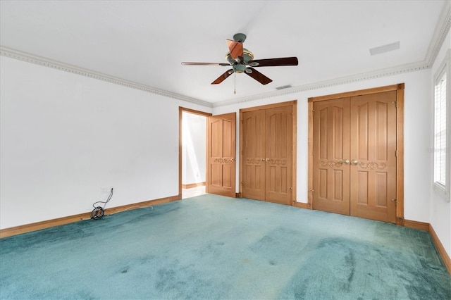 8827 Scout Lake Ct, New Port Richey, FL 34654 - unfurnished bedroom featuring carpet, multiple closets, baseboards, ornamental molding, and ceiling fan