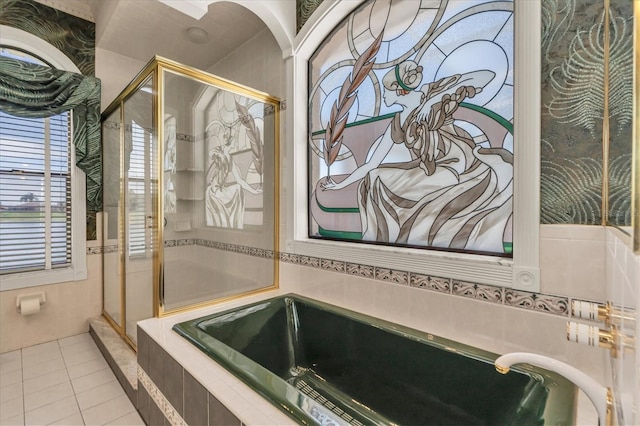 8827 Scout Lake Ct, New Port Richey, FL 34654 - bathroom featuring a shower stall, a bath, and tile patterned flooring